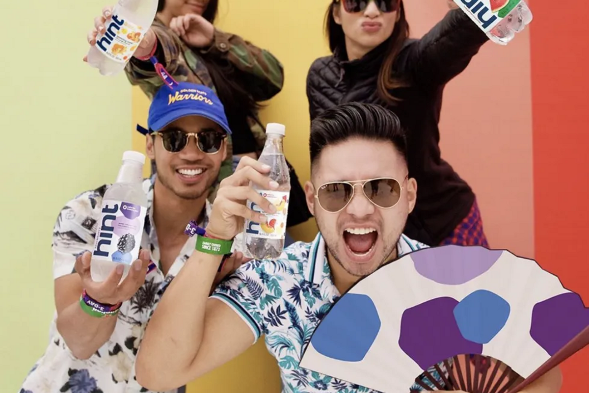 4 people in bright colors holding hint water bottles and smiling