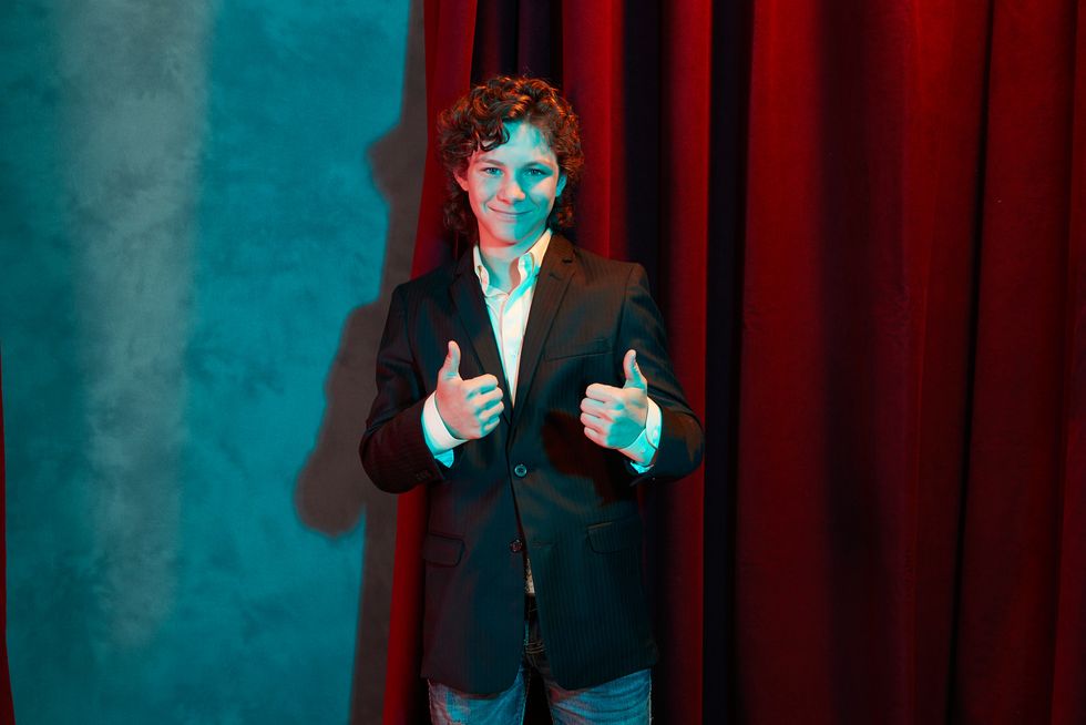 Actor Montana Jordan of TV show Young Sheldon giving two thumbs up.