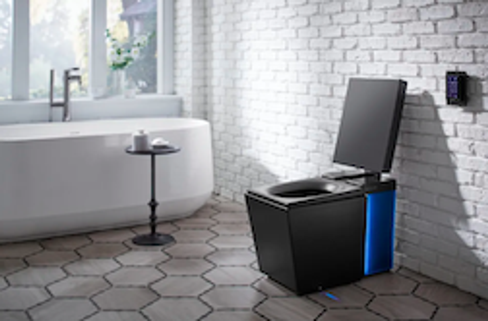 Kohler toilet in a white tiled bathroom