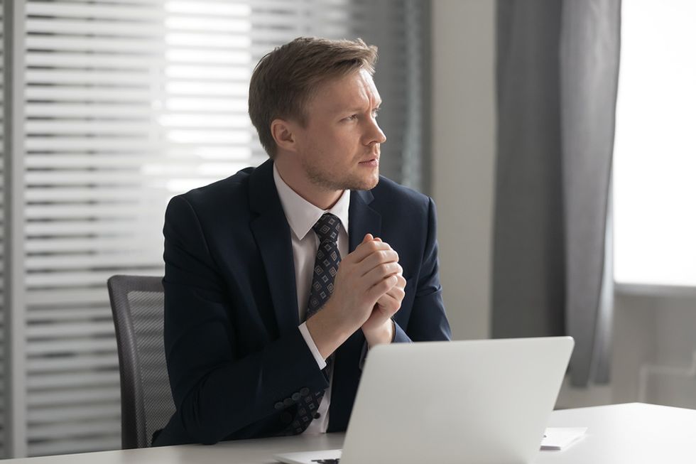 Professional man reflecting on his career after getting demoted at work