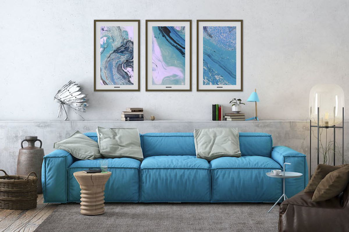 A living room scene with three digital frames on the wall