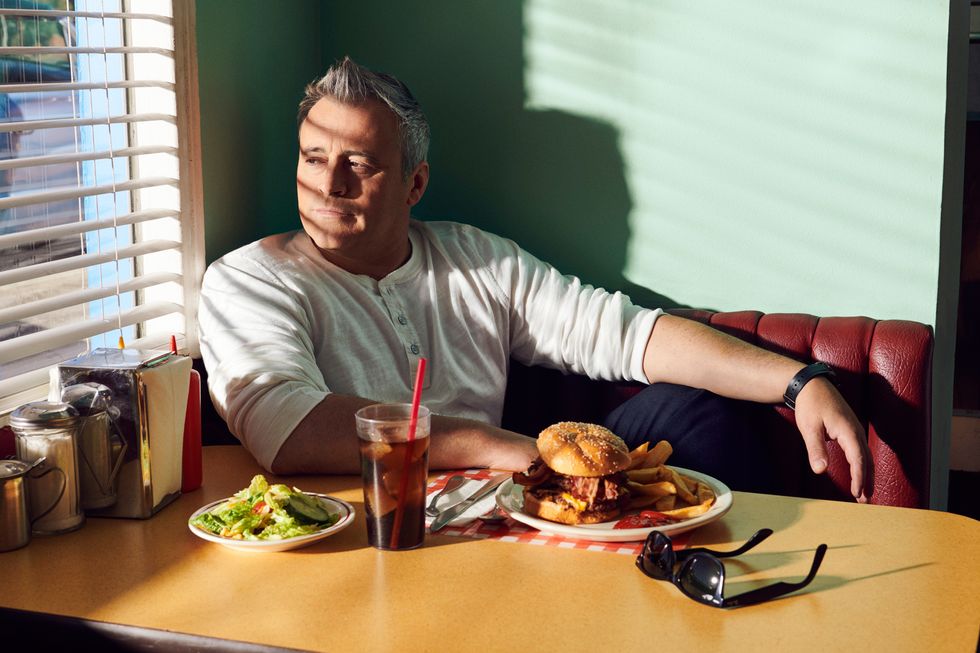 Actor Matt LeBlanc relaxing in a classic 50s diner booth.