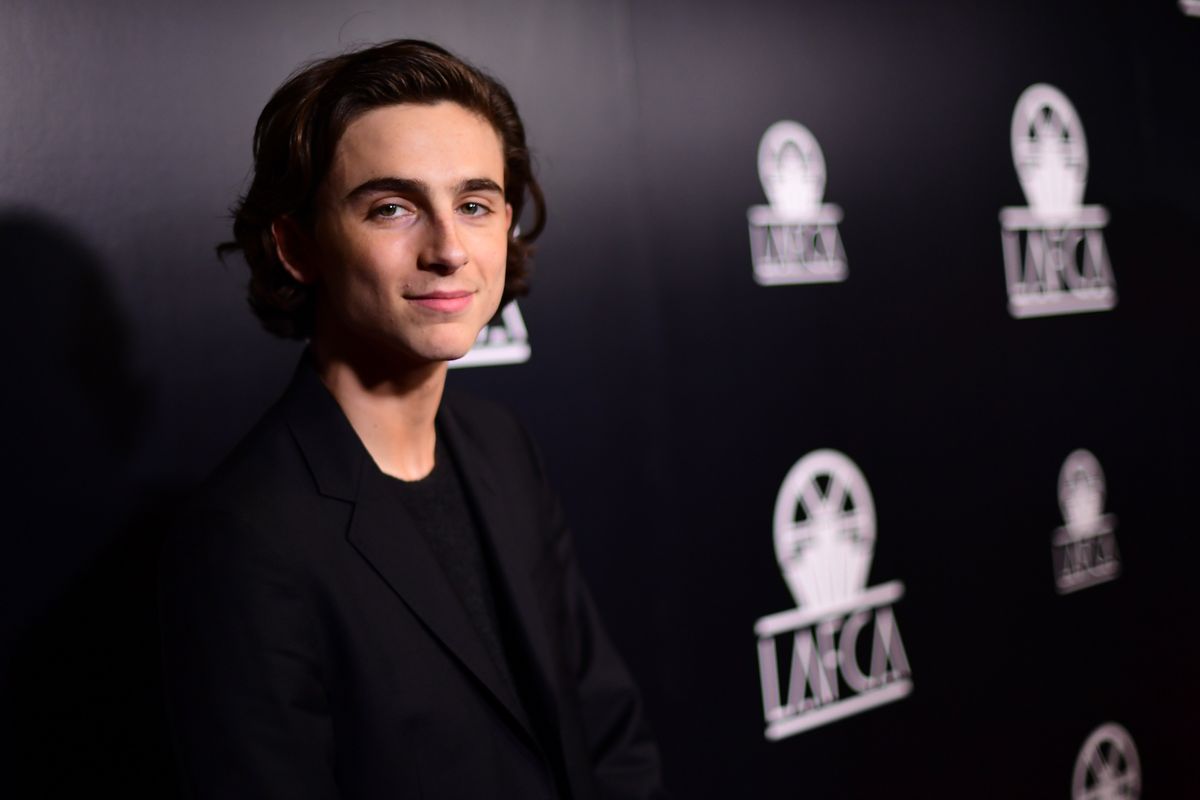 Timothee Chalamet looks ready to rock while walking with a guitar