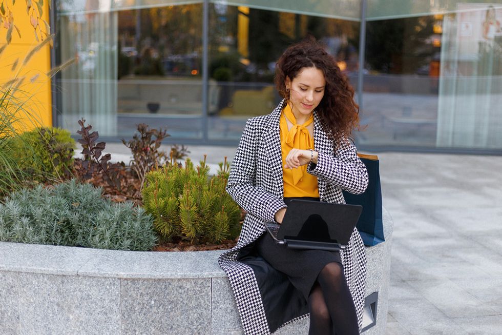 Businesswoman keeps track of the extra hours that she works.