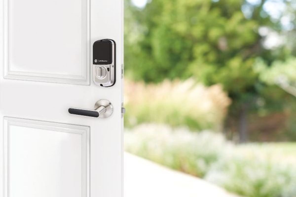 A smart lock from Yale and LiftMaster on a door that opens outside