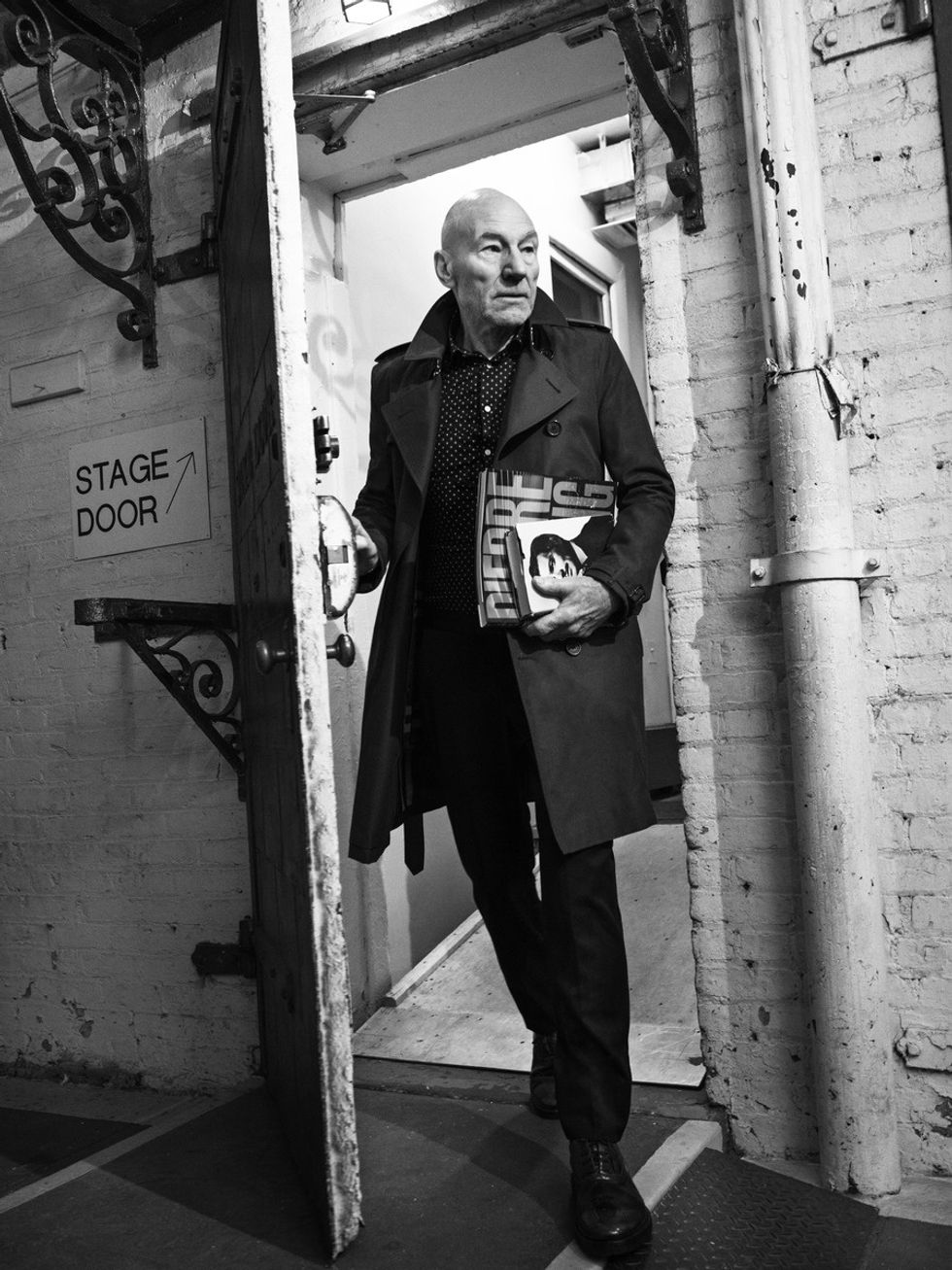 Black and white portrait of Sir Patrick Stewart exiting stage door of a theater.