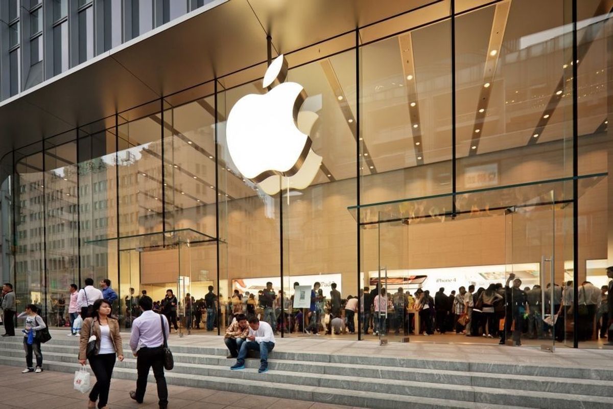 Apple logo on a glass wall at one of its stores