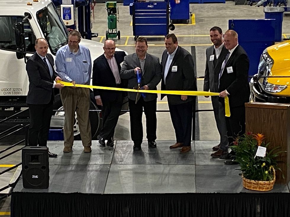 Posing for a ribbon-cutting photo