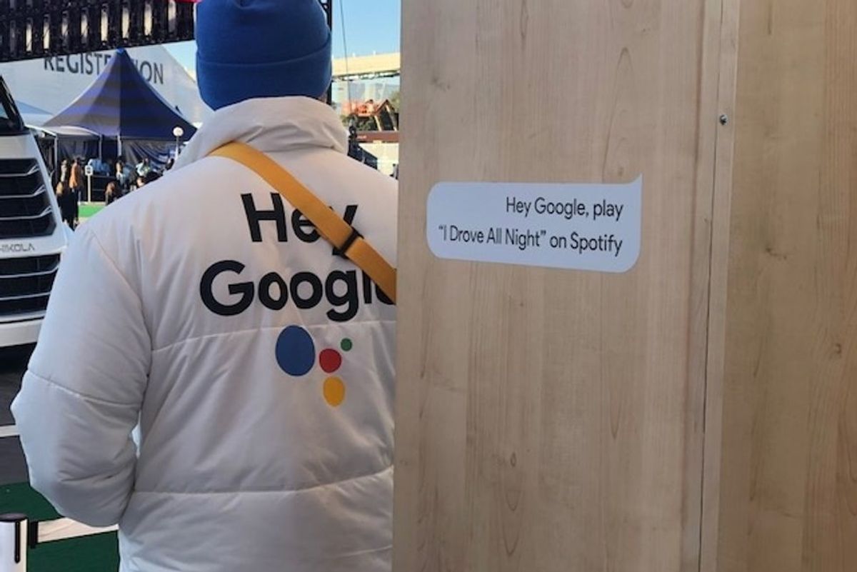 A man in a suit that advertises Google Assistant