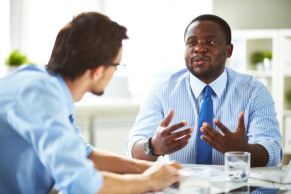 Job candidate answers the question, "Tell me about yourself," during an interview for a marketing position