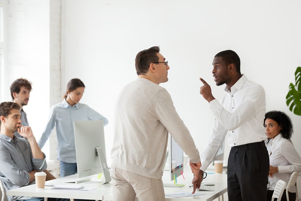 Professional man confronting an annoying co-worker