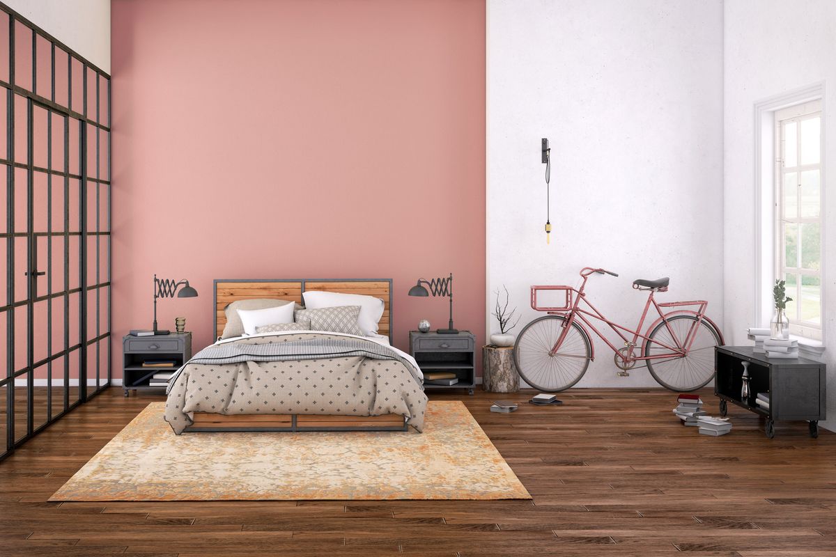 bedroom with bed, pink and white walls with pink bike