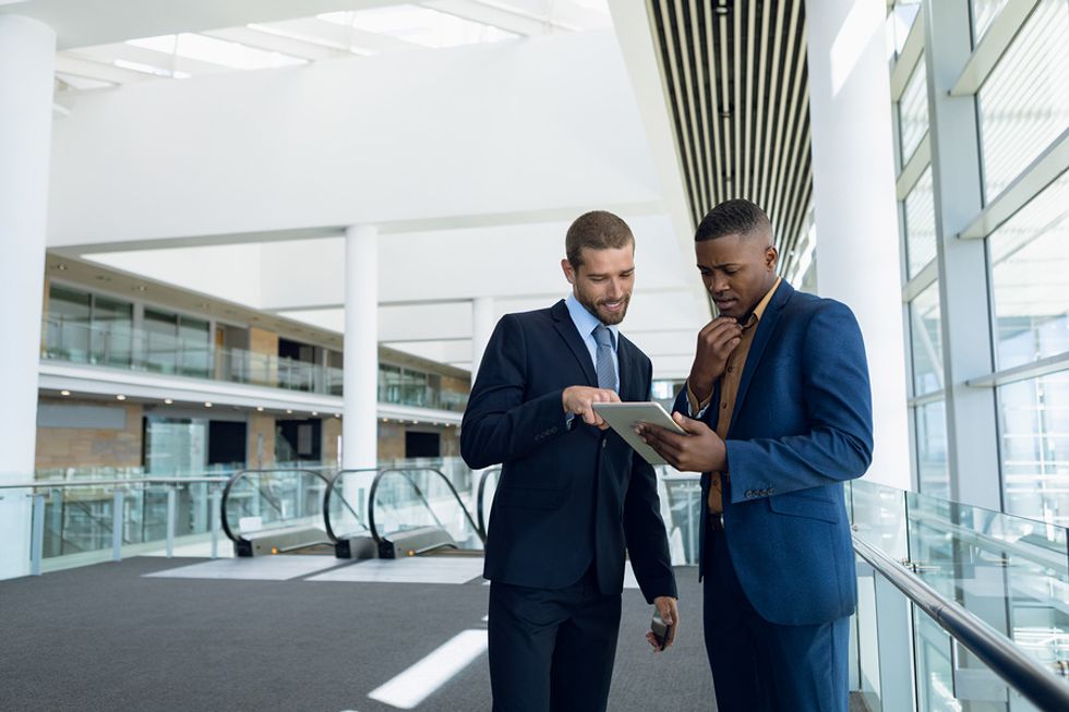 Two professional men talk about career success