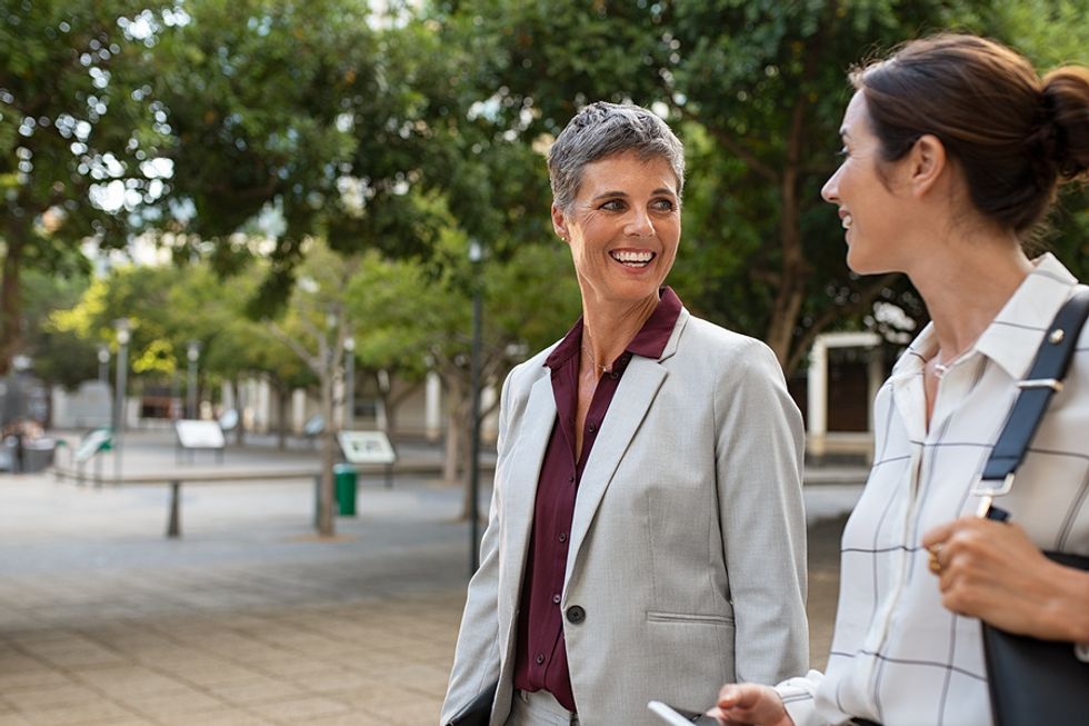 Two professional woman make exercise a daily habit for career success