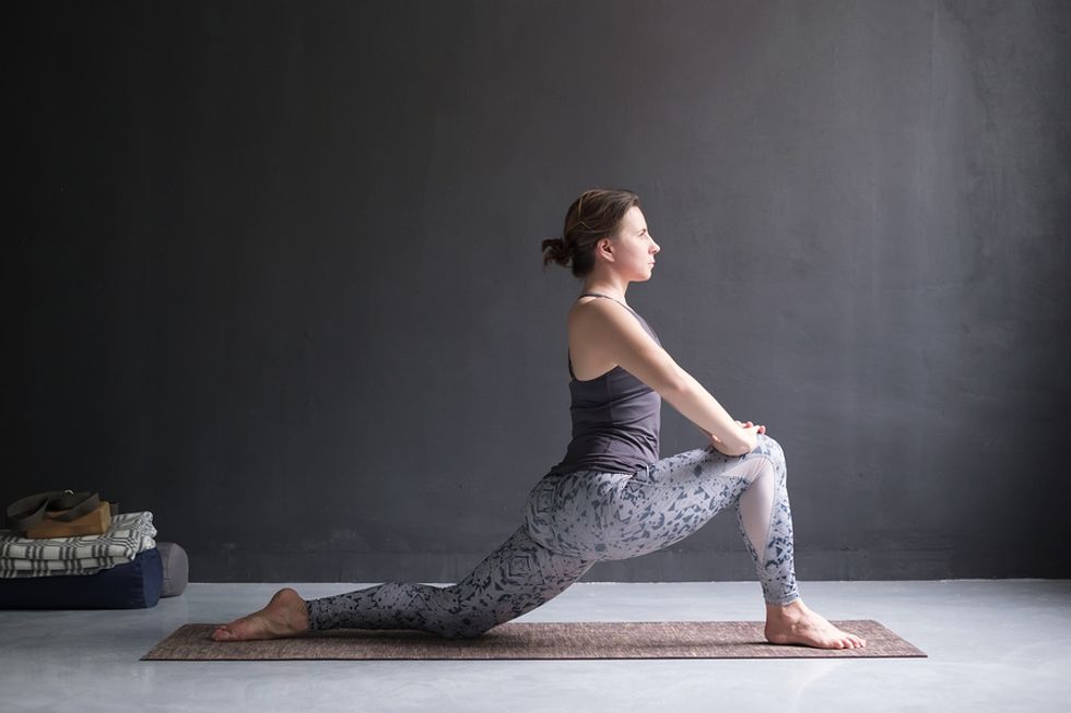 Woman in a low lunge stretching before work