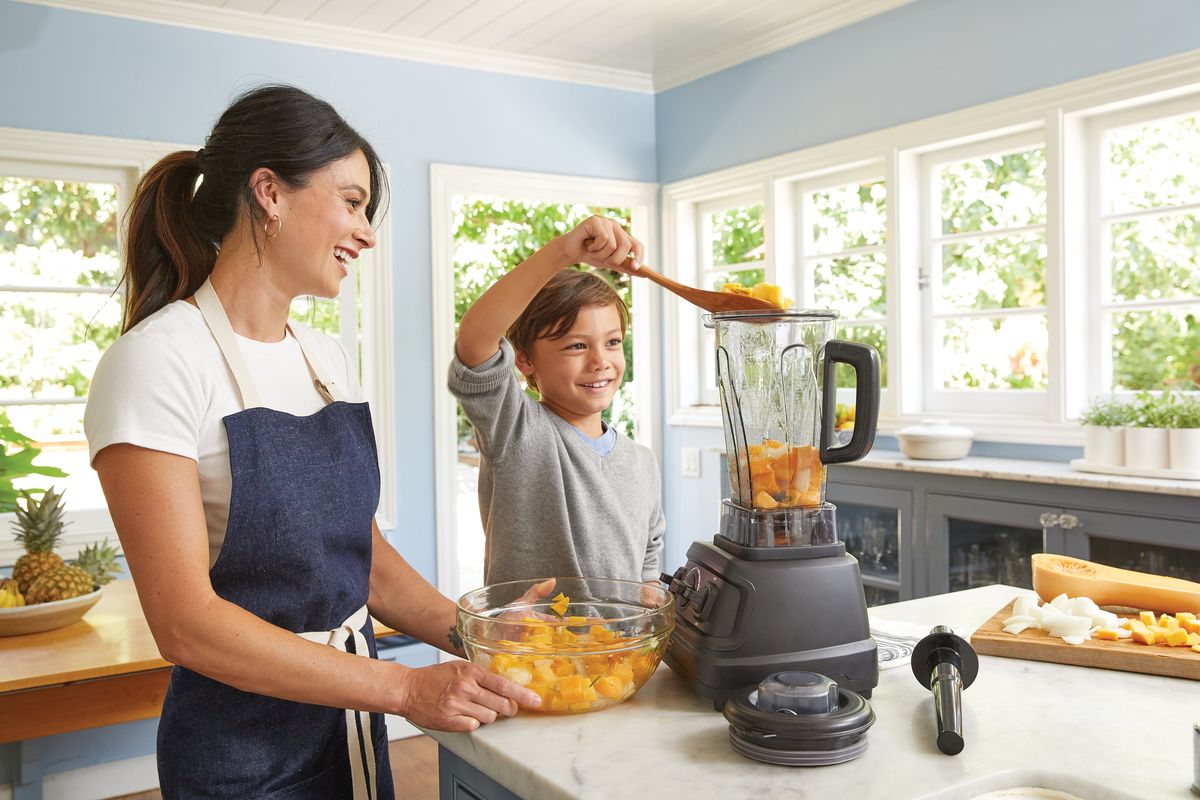 Mother and son making a juice with brandless pro blender