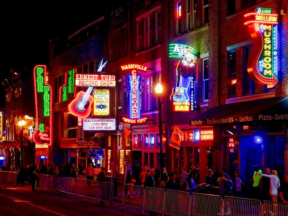 Crowd In Illuminated City At Night