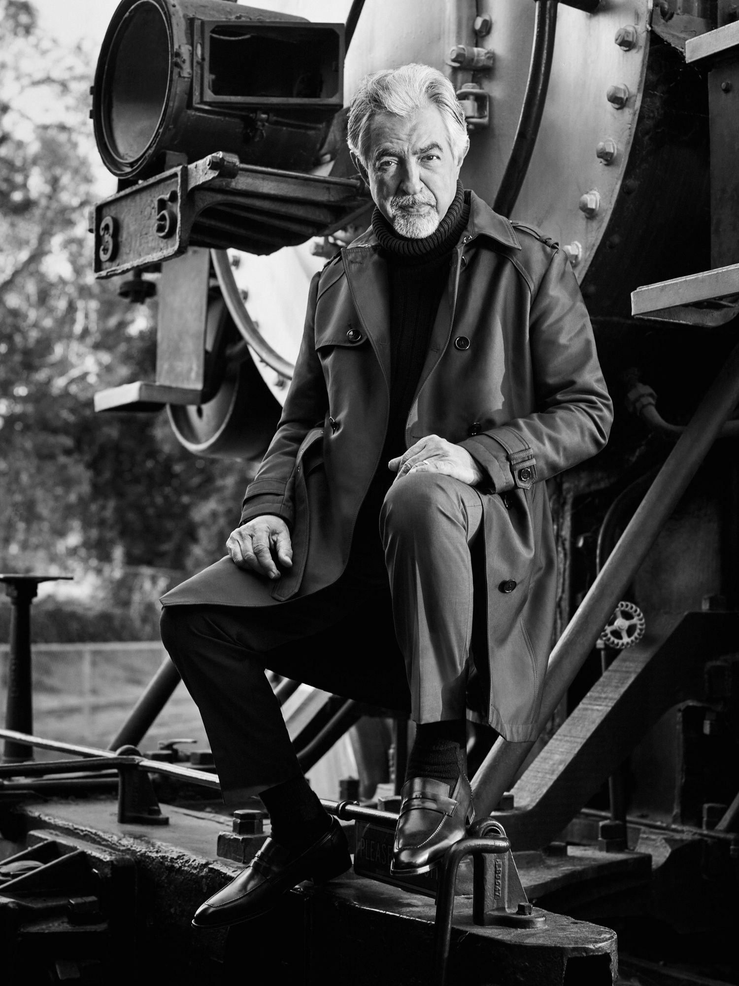 Joe Mantegna of Criminal Minds posing in front of a vintage locomotive.