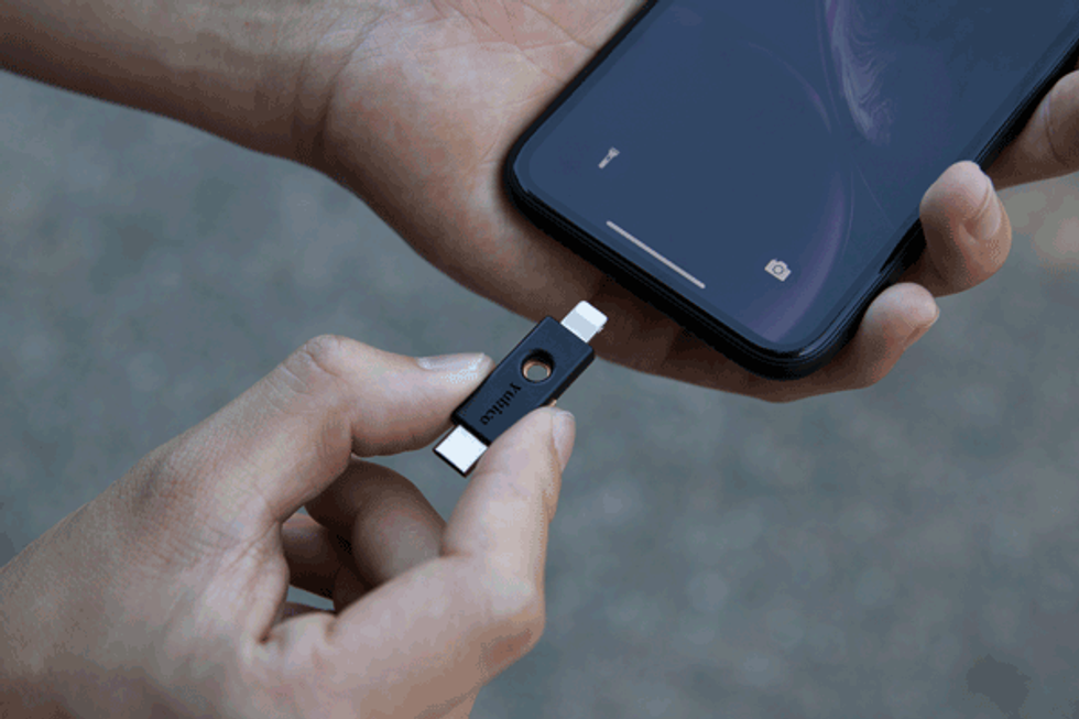 A YubiKey being put into a smartphone