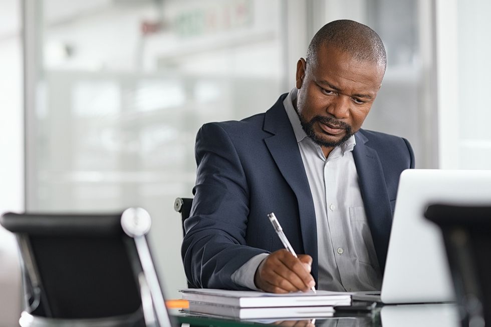 Professional man thinking about a time he went above and beyond at work