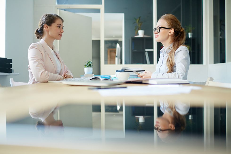 Professional woman practices her answer to the interview question, "Tell me about a time you went above and beyond?"
