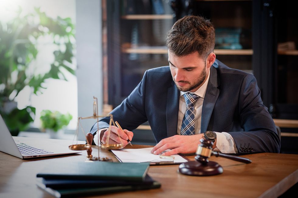 A detail-oriented lawyer signs a document