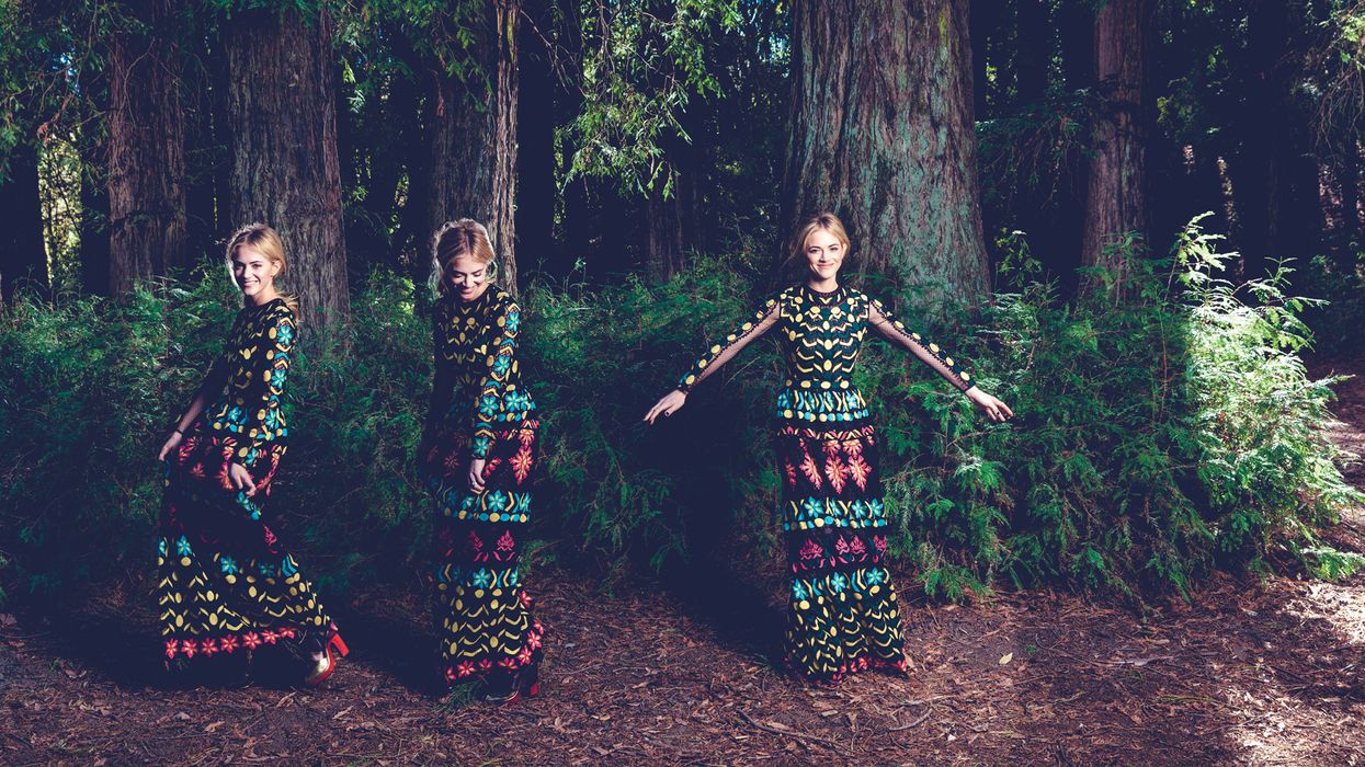 Emily Wickersham frolicking in the forest.