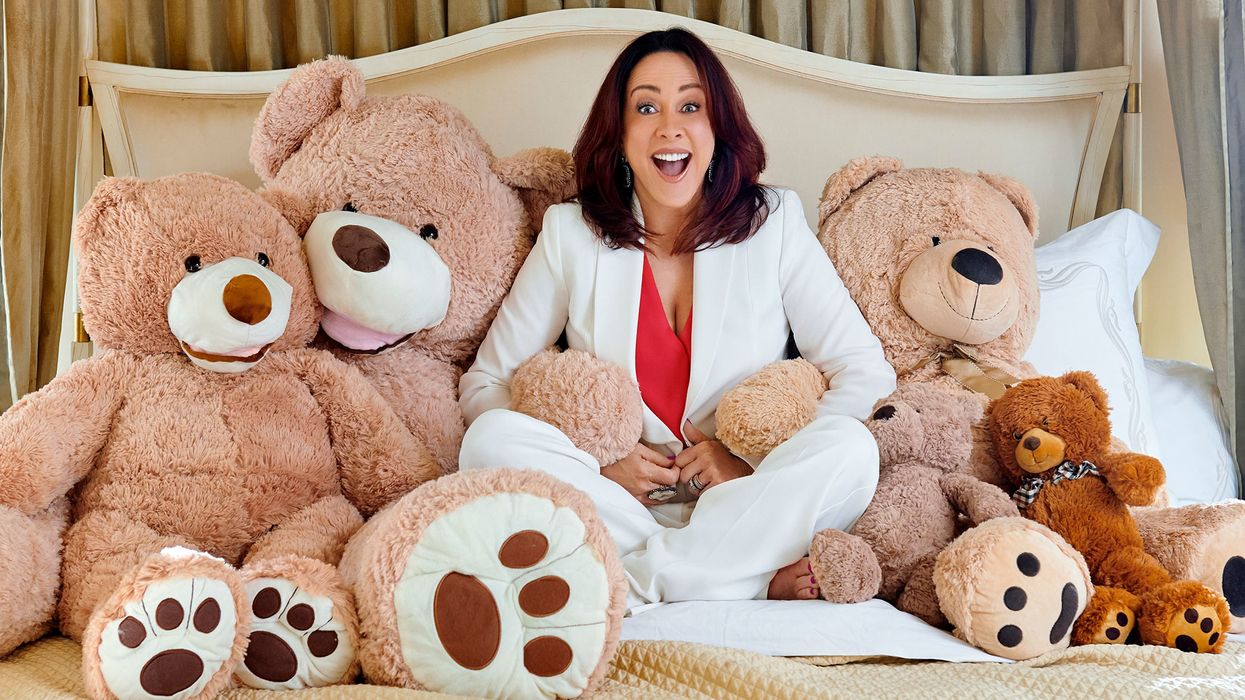 Patricia Heaton surrounded by lots of teddy bears.