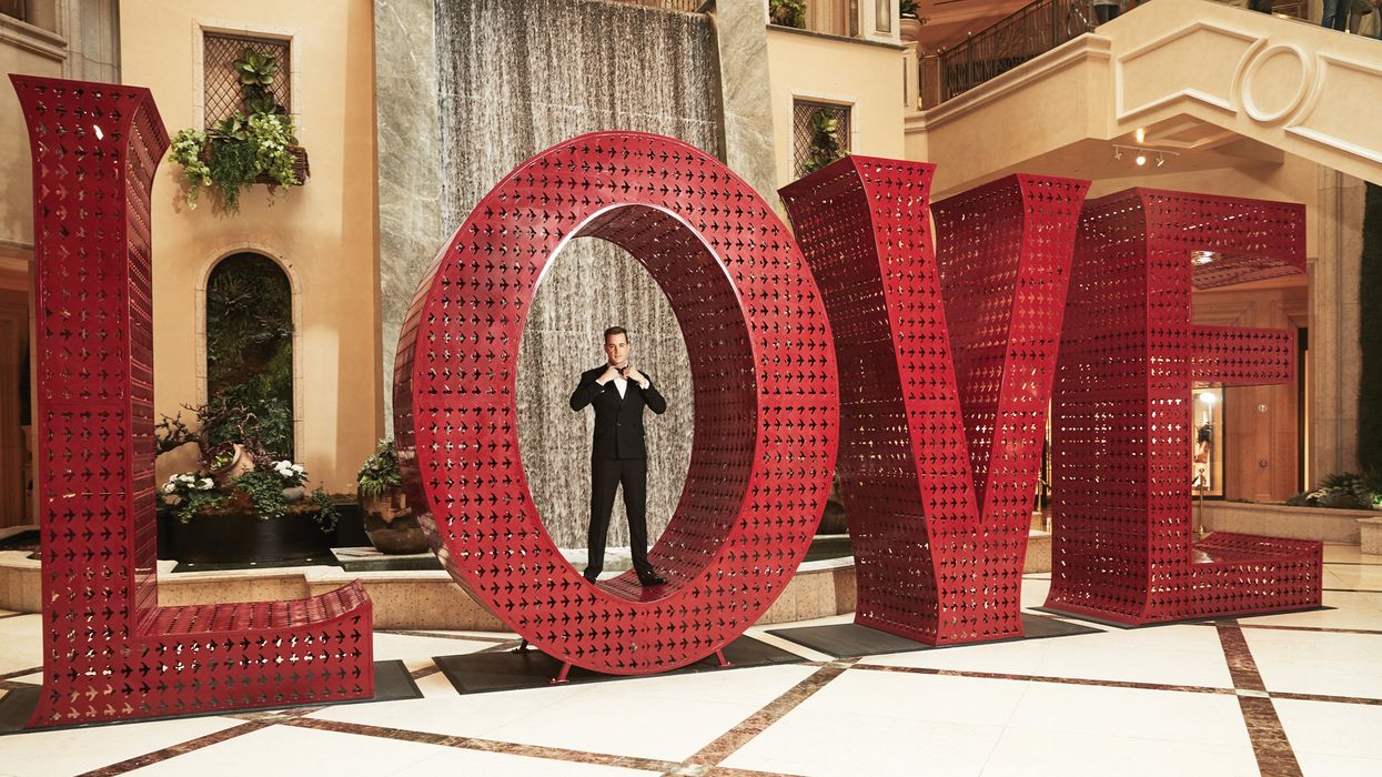Sean Murrray standing in the "O" of the LOVE art installation.