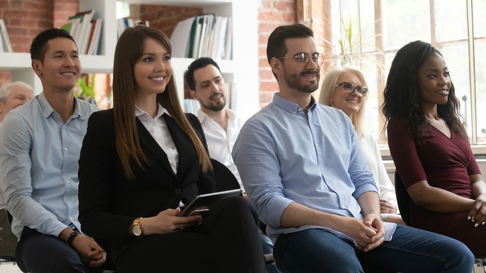 Group of co-workers take a class to learn a new skill