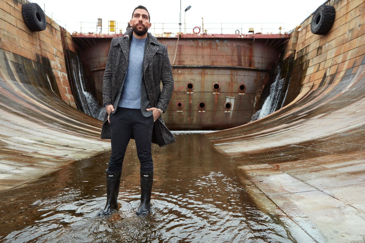 Zeeko Zaki standing in a puddle in belly of a ship.