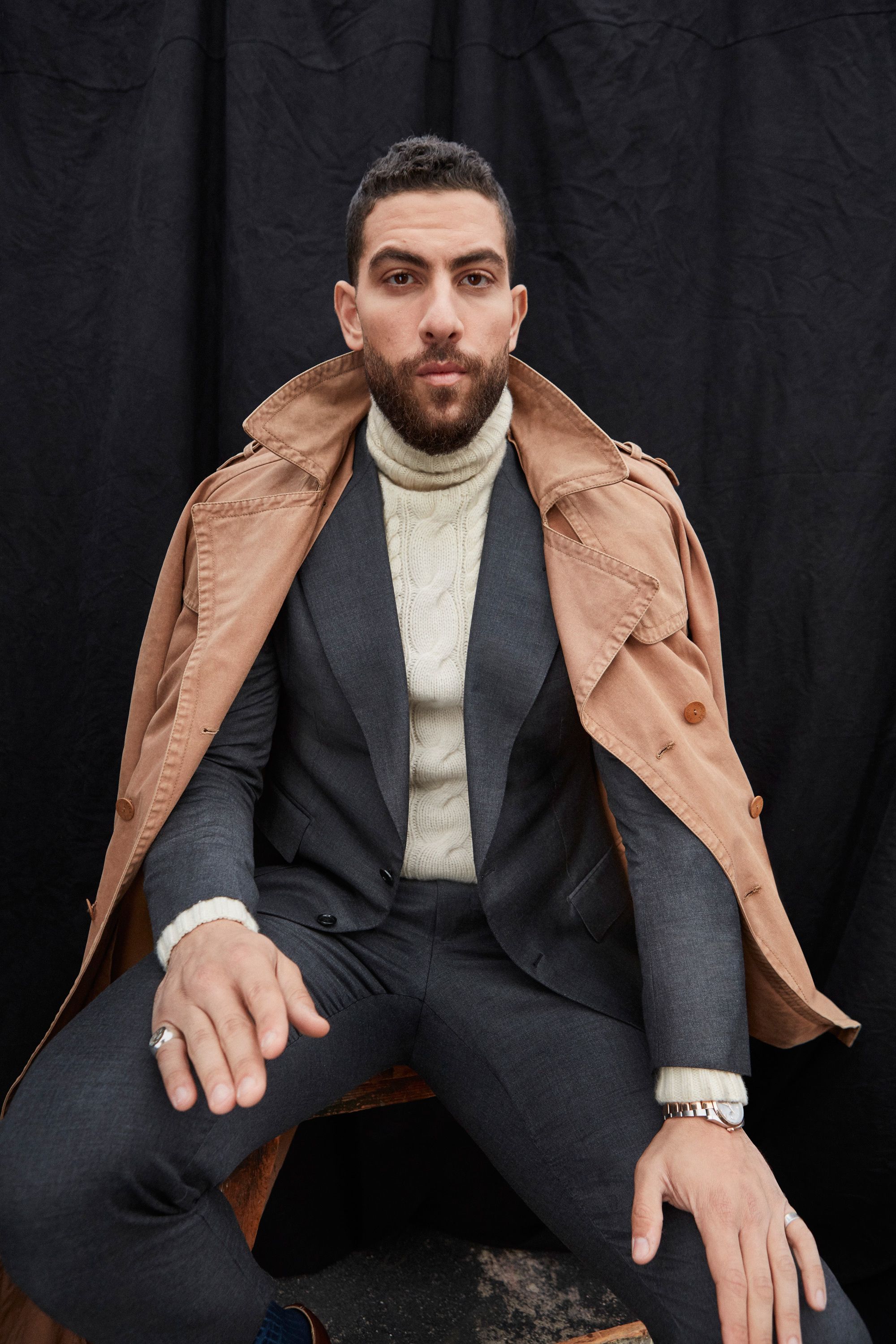 Zeeko Zaki modeling a suit and trench coat.