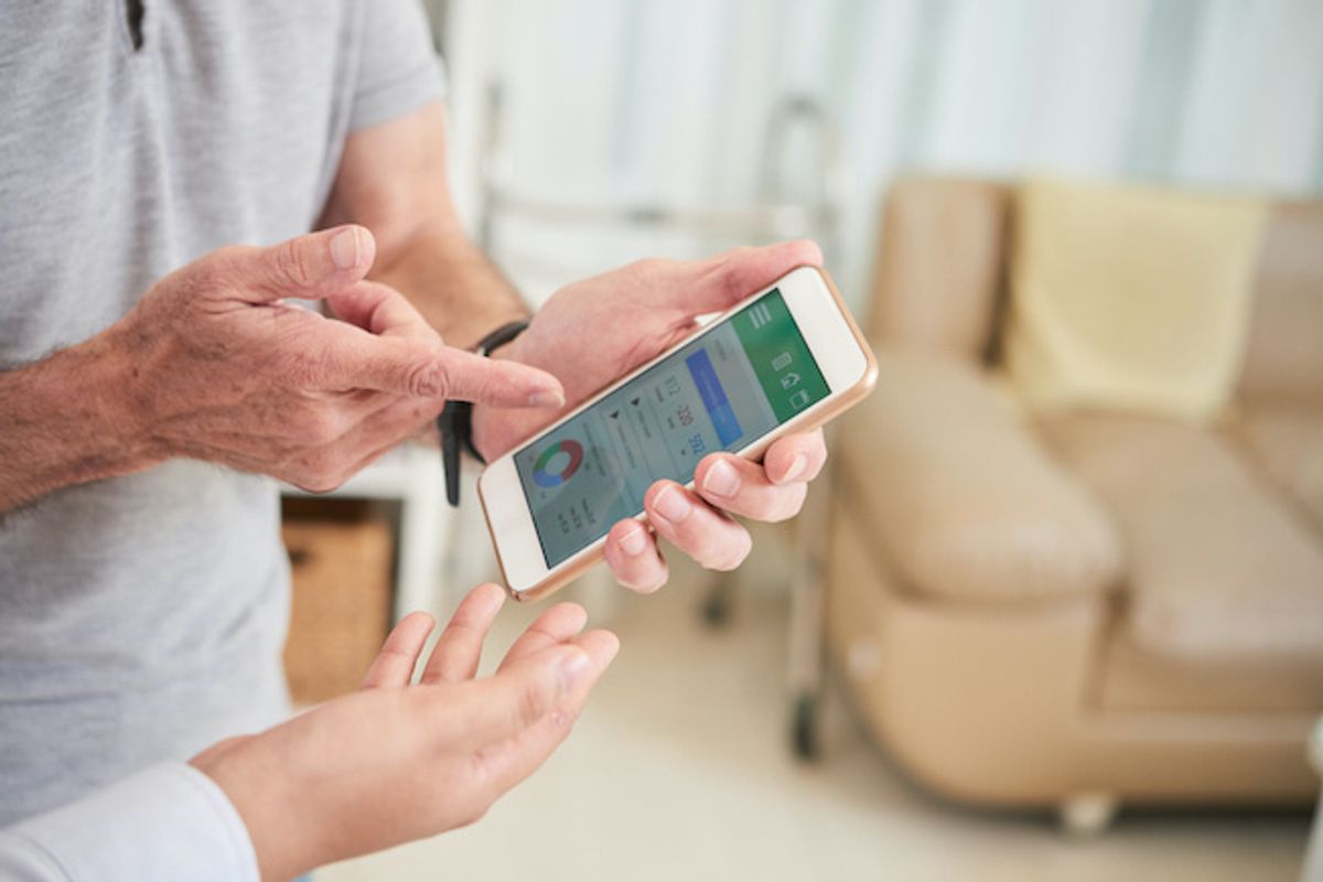 Two people looking at a health app on a smartphone