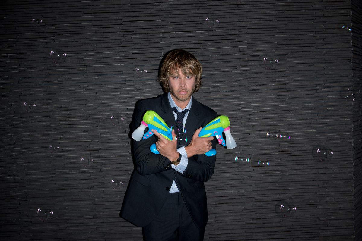 Eric Christian Olsen of NCIS Los Angeles holding bubble guns