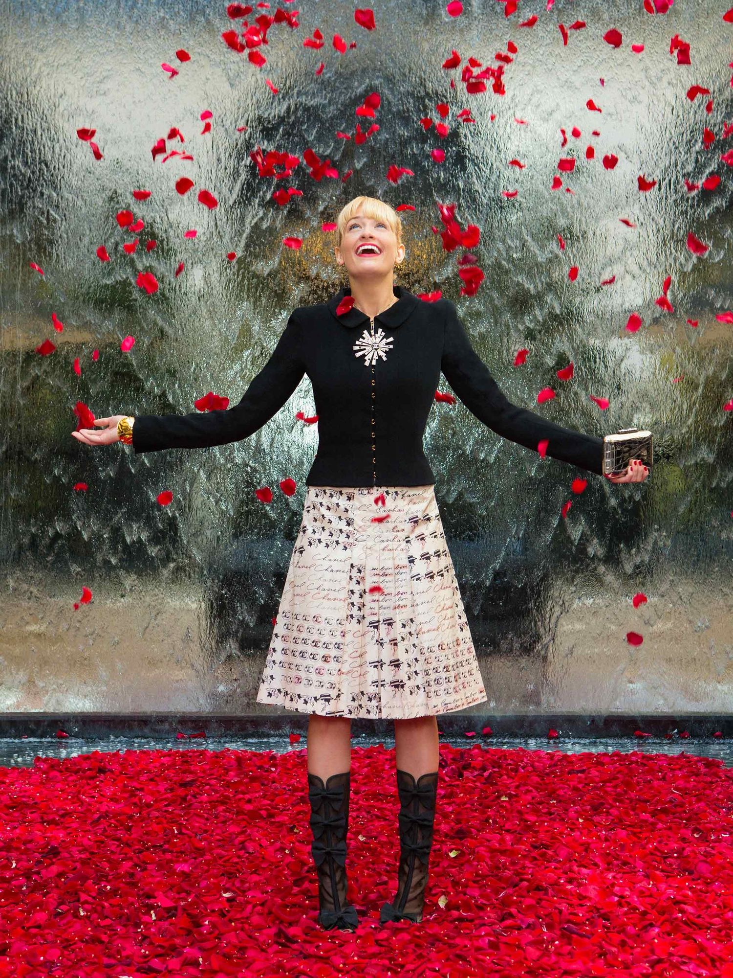 Beth Behrs of The Neighborhood with falling rose petals.