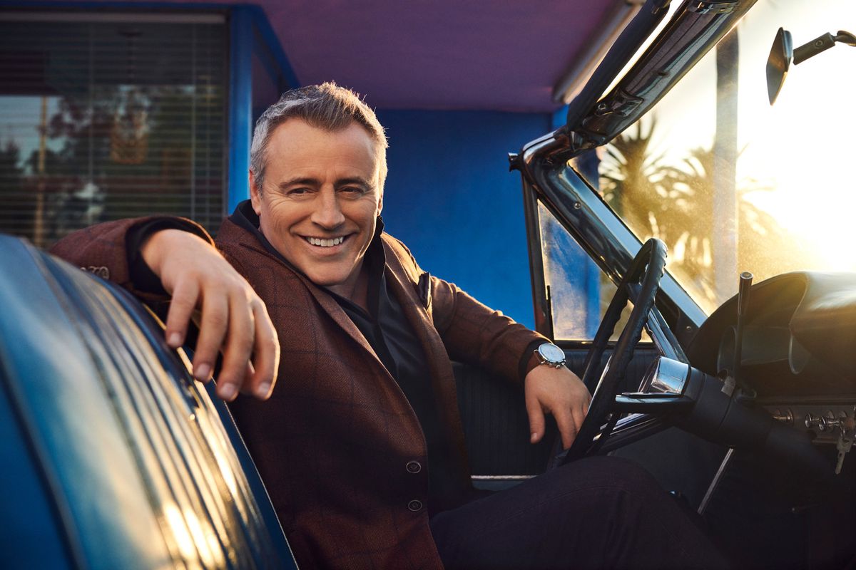 Actor Matt LeBlanc sitting in a classic convertible with the top down.