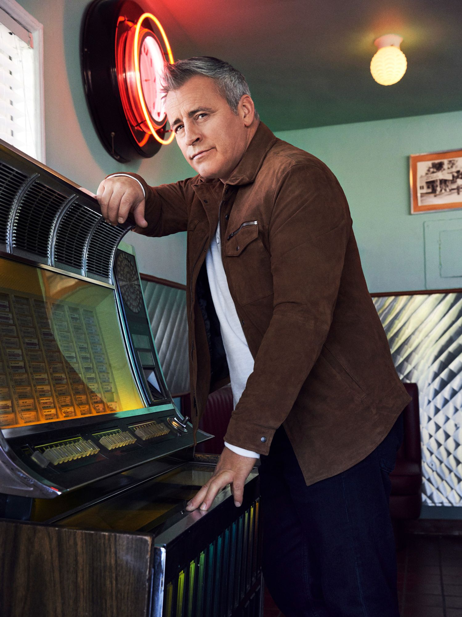 Actor Matt LeBlanc standing at a vintage juke box.