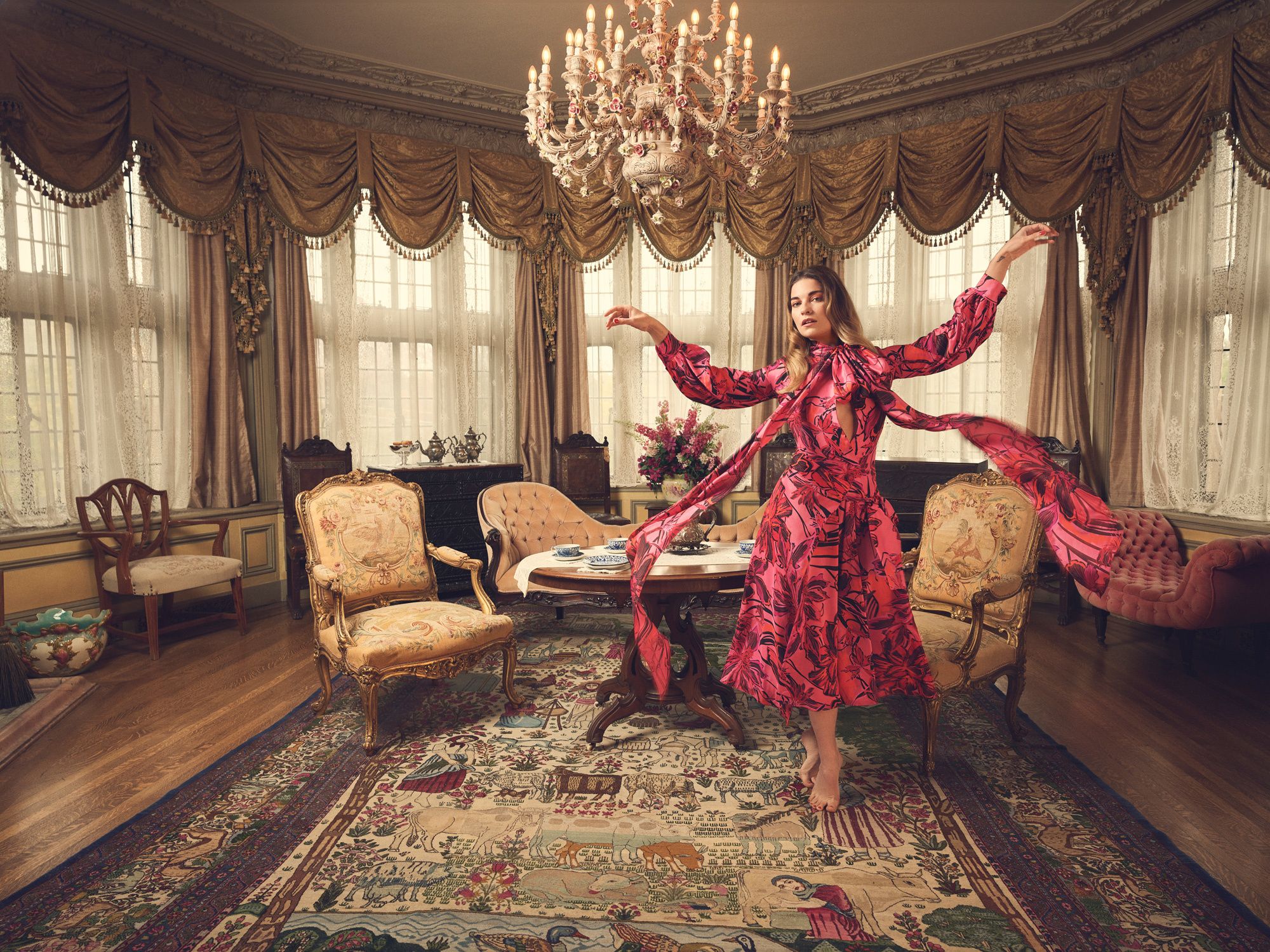 Annie Murphy twirling in an elegant sitting room.