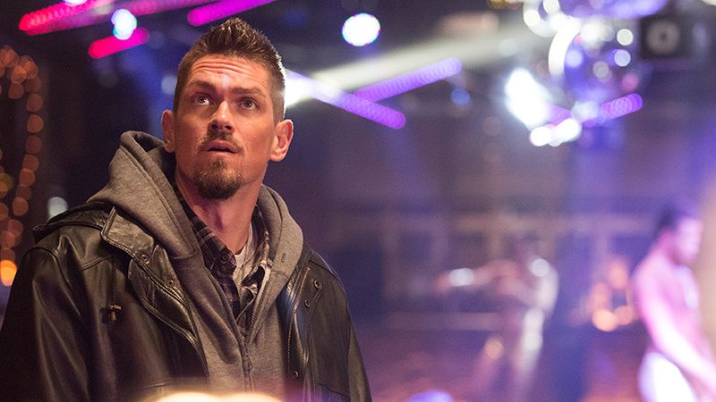 Steven Howey wearing a leather jacket and hoodie.