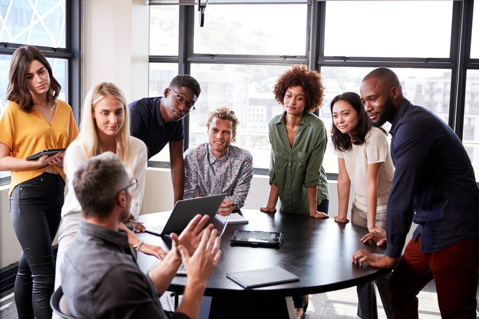 Executive talking to his employees about the importance of workplace culture