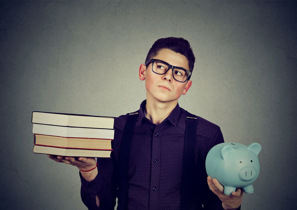 Young man thinking about how much debt he'll be in after going to college