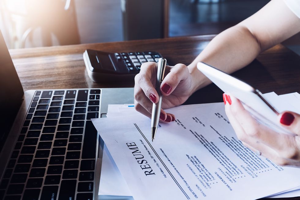 Job candidate reviews her resume to check for correct punctuation