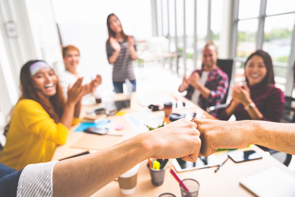Employee celebrating at the end of a team assignment.