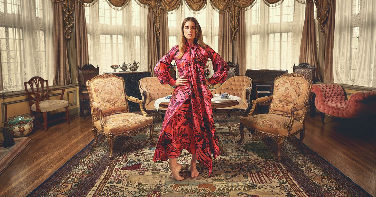 Annie Murphy in a red floral print dress.