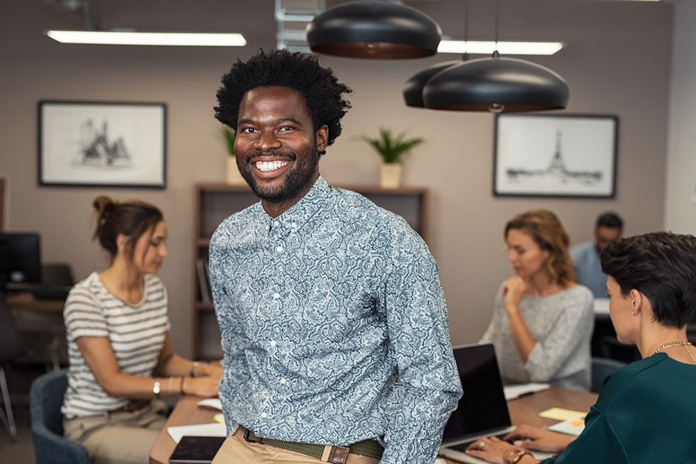 Professional man encourages better workplace culture with random acts of kindness
