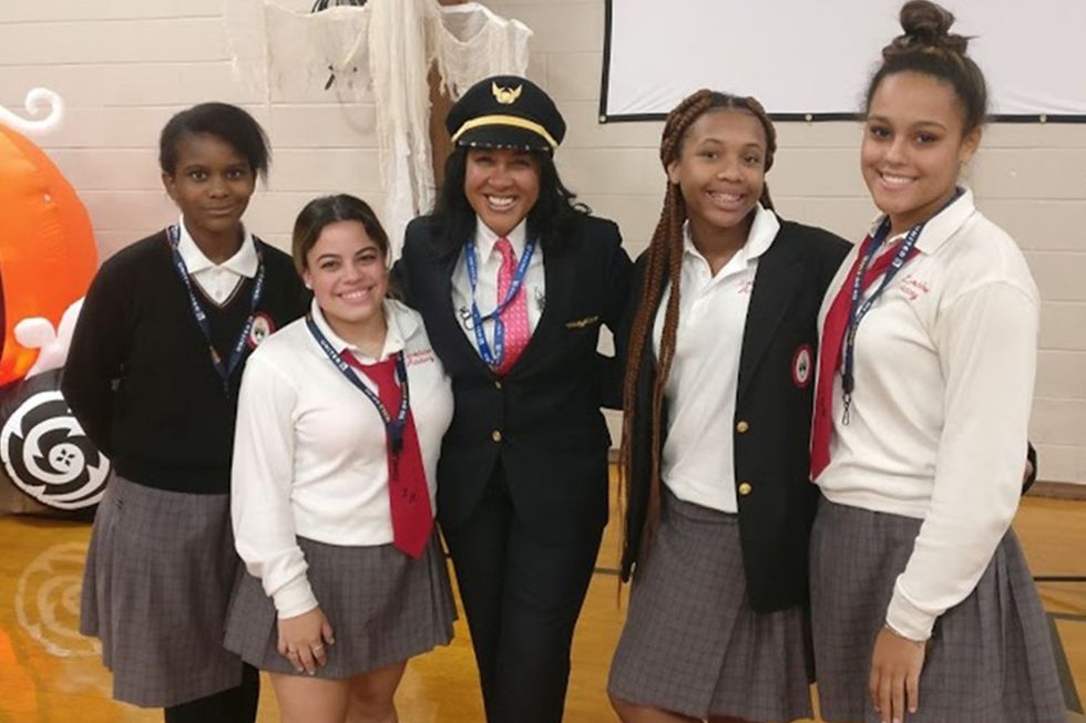 Carole pictured with a group of young women 