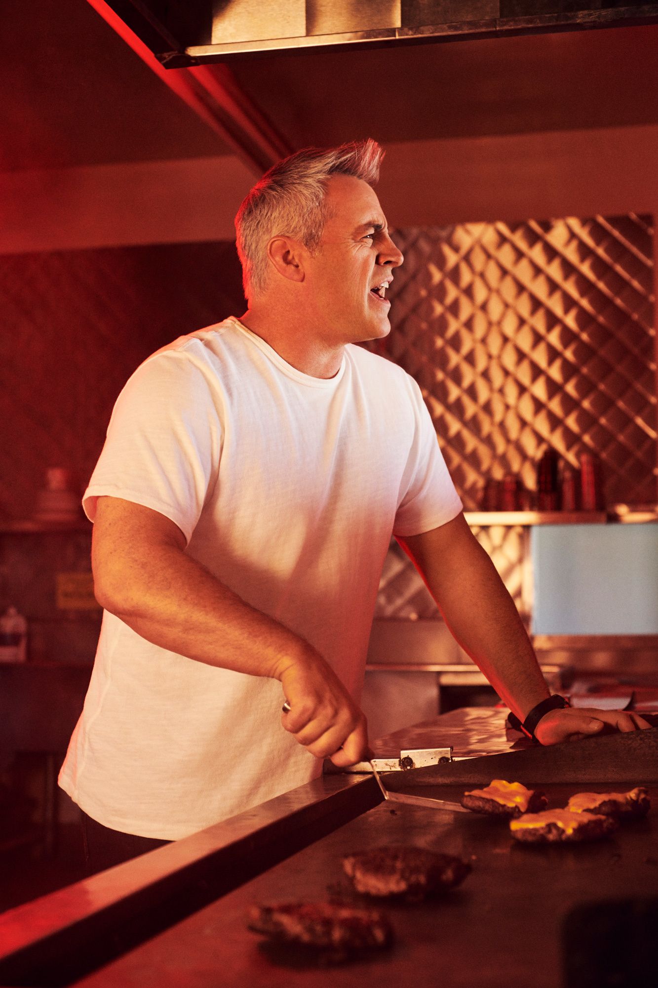 Matt LeBlanc flipping burgers in a classic 50s diner.