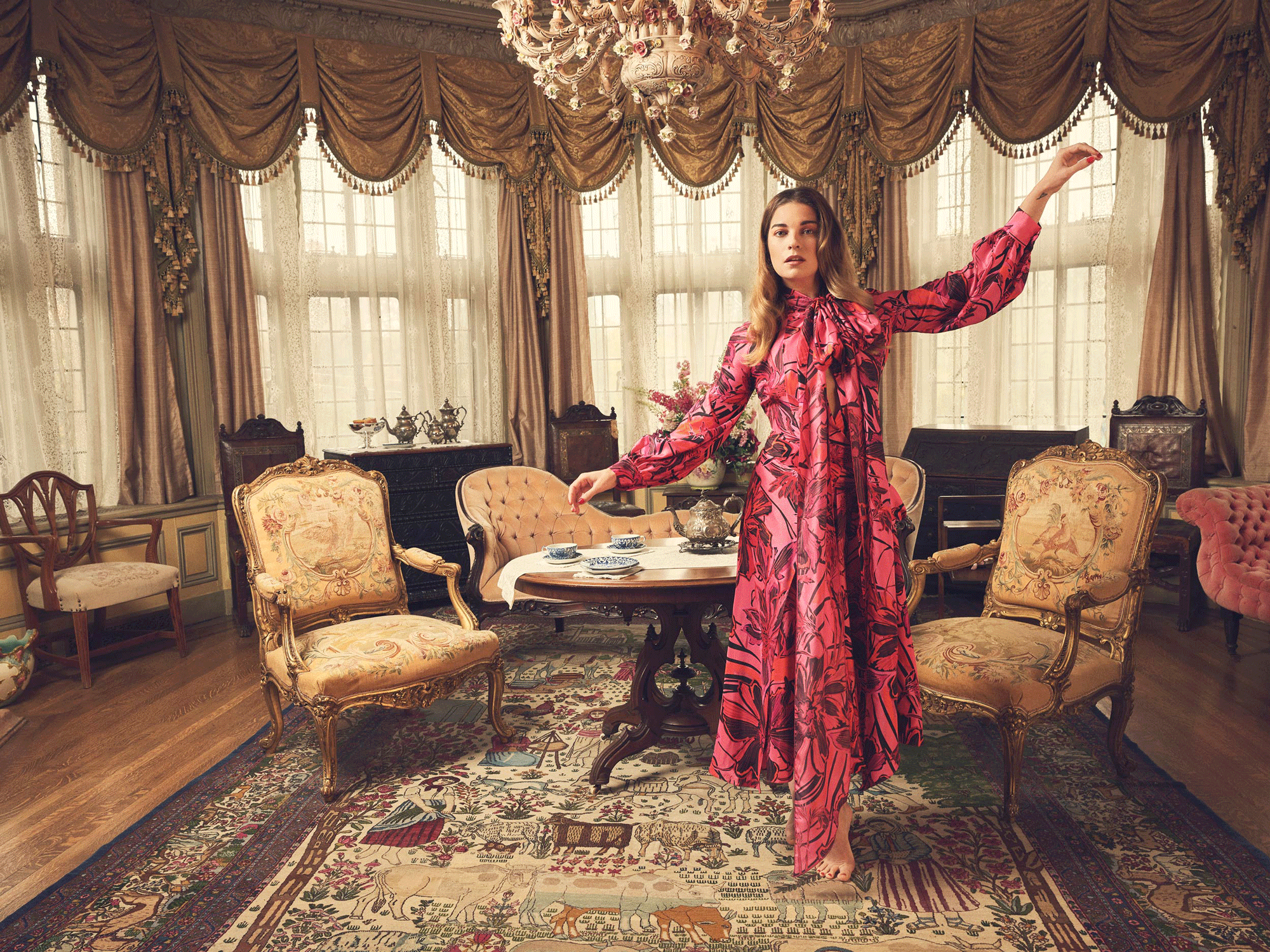 Annie Murphy in a red floral print dress.