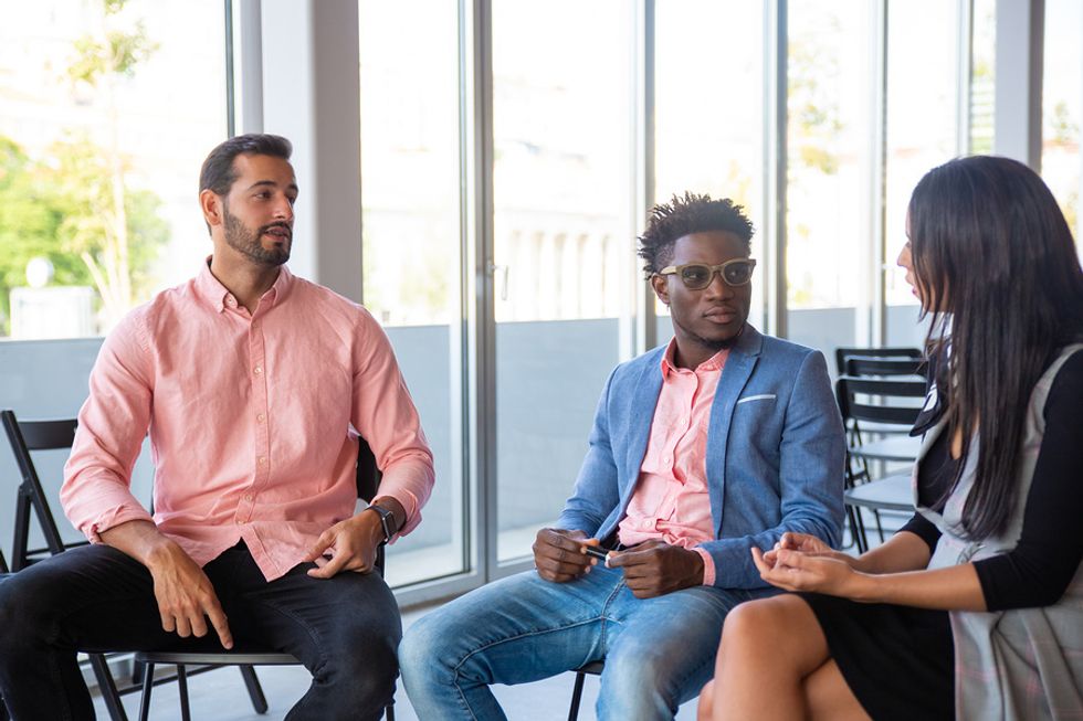 Group of co-workers meet to discuss how to stop workplace harassment