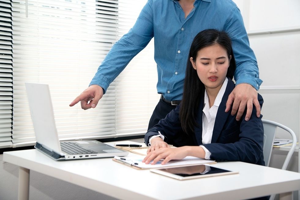 Woman experiences physical harassment in the workplace